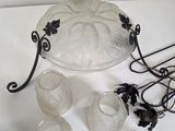 a white table with a glass bowl and other items on it