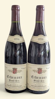 two bottles of wine sitting next to each other on a table
