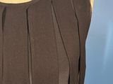 a woman ' s black dress with pleas on a mannequin mannequin mannequin mann