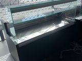 a glass display case with a lot of food inside of it