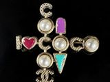 an image of a cross with pearls and jewels