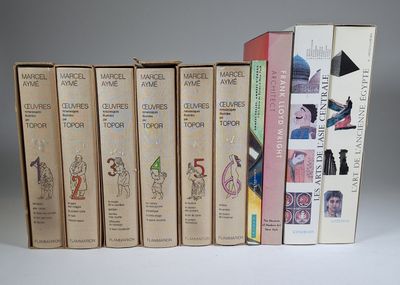 several books are stacked on top of each other on a table