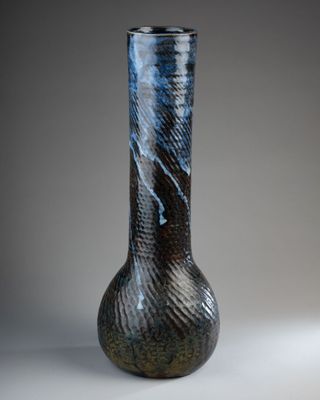 a black and blue vase sitting on a table