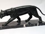 statue of a black panther on a marble base on a white background