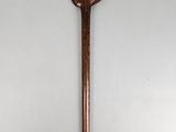an old wooden stick with a bird on top of it