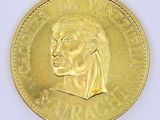 gold coin with a portrait of a man ' s head on it