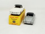 two toy cars sitting next to each other on a box