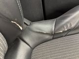 a close up of a seat in a car with a broken arm rest