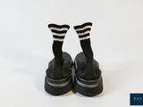 pair of black and white striped socks on a pair of black and white striped shoes