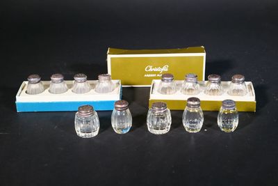 six salt and pepper shakers and a box of salt and pepper shakers