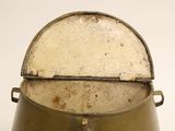 an old metal pot with a lid on a table