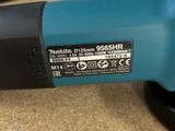 an electric polisher sitting on top of a table next to a roll of paper