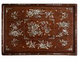 a wooden tray with a floral design on it
