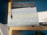a stack of papers sitting on top of a wooden shelf