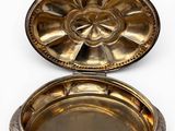 an image of a silver plate with a flower design on it