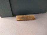 an image of a gold plate on a green bag