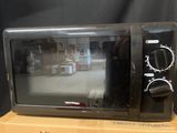 a microwave sitting on top of a box on a table
