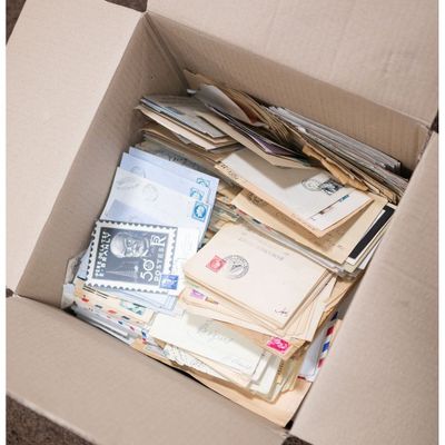 a box full of mail sitting on the floor
