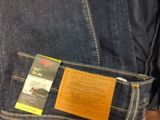 a close up of a pair of jeans with a tag on it