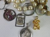 a pile of jewelry on a table with a keychain