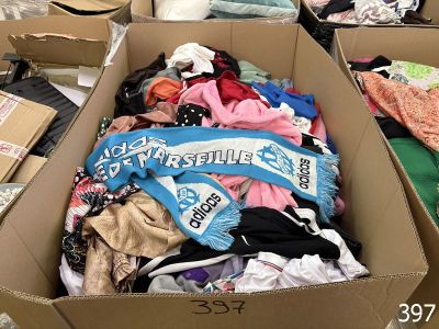 a cardboard box filled with clothes and other items