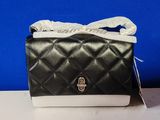 black and white quilted purse with a bow on top