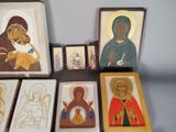 many paintings of the virgin and child on the table