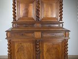 a large wooden cabinet with two doors on top of it