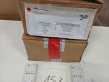a box with two remote controls and a sign on it