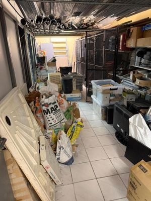 a room with a refrigerator and many boxes in it