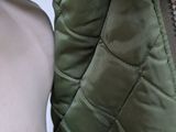 a woman wearing a green jacket and a white shirt