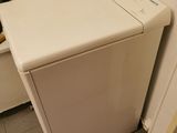 a white washer and dryer in a small room