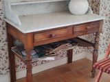 a desk with a mirror and a chair in a room