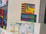 a lot of art work on the floor next to each other