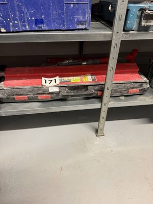 a shelf full of tools in a room with a lot of shelves