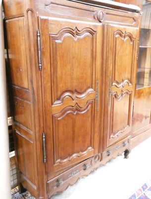 a large wooden cabinet with a mirror on top of it