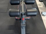 an image of a gym room with a row of machines