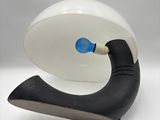 a black and white object with a blue light on it