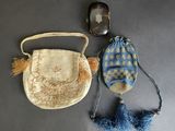two purses and a cell phone on a table