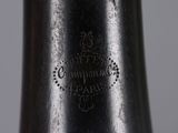 a close up of a silver vase with a black label on it