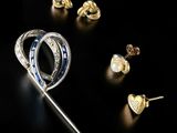 several different types of jewelry are displayed on a black surface