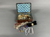 a small wooden box filled with jewelry on a table