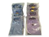 two sets of men ' s dress shirts in plastic bags on a white surface