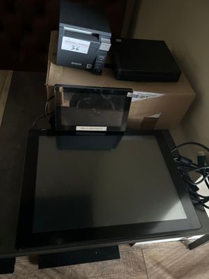 a tablet computer sitting on top of a table next to a laptop computer