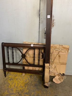 a wooden bed frame with a mirror on top of it