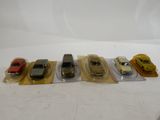 five toy cars lined up in a row on a table