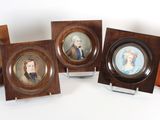 four framed portraits of people are sitting on a table