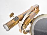 a close up of a clock with a telescope on it