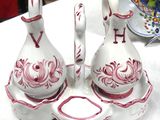 two white and red vases sitting on a white table