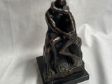 statue of a man and a woman sitting on a rock